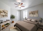 Thumbnail 26 of 37 - a bedroom with a large bed and a ceiling fan