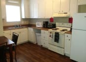 Thumbnail 16 of 27 - a kitchen with white appliances and white cabinets