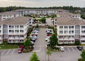 Thumbnail 23 of 25 - A parking lot in front of apartment buildings.at Residence at Marina Bay, Irmo South Carolina