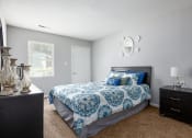 Thumbnail 3 of 27 - a bedroom with a bed and a dresser and a window