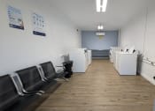 Thumbnail 16 of 28 - a break room with chairs and counters and a door