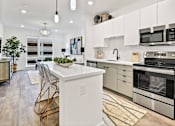 Thumbnail 25 of 47 - A modern kitchen with white cabinets and stainless steel appliances. at The Palms 1101, Columbia, SC, 29201