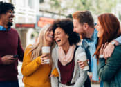 Thumbnail 2 of 21 - a group of people laughing and drinking coffee