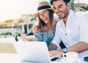 Thumbnail 3 of 29 - a man and woman sitting at a table with a laptop