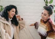 Thumbnail 12 of 28 - two women sitting on a couch laughing