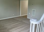 Thumbnail 30 of 30 - an empty room with a staircase and a door in the background