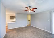Thumbnail 15 of 27 - an empty living room with a ceiling fan