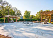 Thumbnail 24 of 27 - a patio with tables and chairs and a pavilion