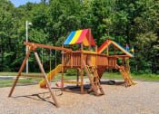 Thumbnail 3 of 27 - a playground with a swing set and a slide