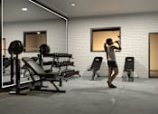 Thumbnail 20 of 22 - A woman is working out in a gym with a variety of equipment.