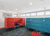 Thumbnail 16 of 22 - A room with blue and red chairs and a red rug.