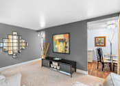 Thumbnail 14 of 50 - a living room with a couch and a table