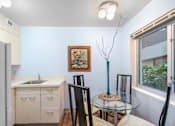 Thumbnail 15 of 50 - a kitchen and dining room with a glass table and chairs
