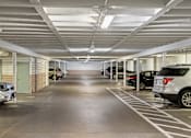 Thumbnail 50 of 50 - a parking garage with cars parked in it