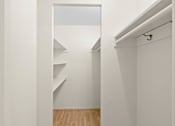 Thumbnail 46 of 50 - a room with white walls and a closet with shelves