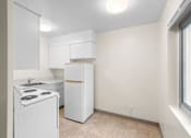 Thumbnail 41 of 50 - a white kitchen with white appliances and a window