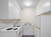 Thumbnail 42 of 50 - a white kitchen with white appliances and white cabinets