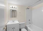 Thumbnail 47 of 50 - a white bathroom with a white sink and toilet and a tub