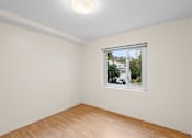 Thumbnail 45 of 50 - a room with white walls and a window and a wooden floor