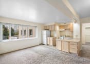 Thumbnail 31 of 50 - a kitchen with a large window and a sink and a refrigerator