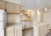 Thumbnail 27 of 50 - a kitchen with white appliances and wooden cabinets