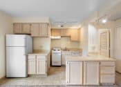 Thumbnail 29 of 50 - a kitchen with wood cabinets and a refrigerator and a stove