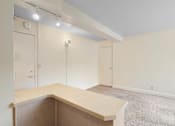 Thumbnail 28 of 50 - a empty living room with a counter top and a closet