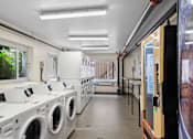 Thumbnail 49 of 50 - a laundry room with washers and dryers and a row of washing machines