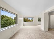 Thumbnail 26 of 50 - the living room has large windows and a carpeted floor