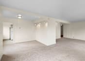 Thumbnail 35 of 50 - a living room with white walls and a carpet floor