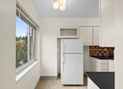 Thumbnail 24 of 50 - a kitchen with a refrigerator and a window