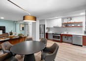 Thumbnail 12 of 50 - a kitchen and dining room with a table and chairs