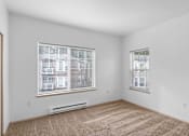 Thumbnail 15 of 29 - a living room with two windows and a carpeted floor at Oriel Apartments, Portland, Oregon