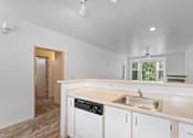 Thumbnail 26 of 29 - a kitchen with white cabinets and a sink and a window at Oriel Apartments, Portland, OR