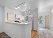 Thumbnail 17 of 29 - a kitchen with a counter top and a refrigerator at Oriel Apartments, Portland