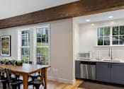 Thumbnail 8 of 29 - a kitchen with a table and a counter with two microwaves at Oriel Apartments, Portland, OR, 97225