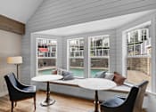 Thumbnail 6 of 29 - a screened in porch with tables and chairs and a pool at Oriel Apartments, Portland, Oregon