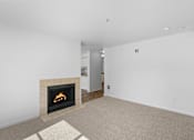Thumbnail 27 of 50 - a living room with a fireplace and a carpet at Summer Creek Apartments, Tigard, OR