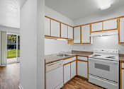 Thumbnail 39 of 50 - a kitchen with white appliances and wooden cabinets at Summer Creek Apartments, Tigard, OR, 97223