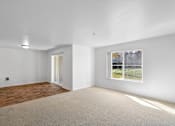 Thumbnail 45 of 50 - a living room with white walls and a window at Summer Creek Apartments, Oregon