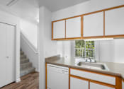 Thumbnail 20 of 50 - a kitchen with a sink and a window and a staircase at Summer Creek Apartments, Oregon, 97223