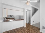 Thumbnail 12 of 50 - a living room with a kitchen and a ceiling fan at Summer Creek Apartments, Tigard