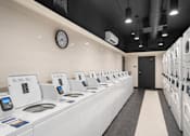 Thumbnail 45 of 47 - a laundry room with a counter and a clock on the wall