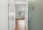 Thumbnail 22 of 47 - an empty room with a door open to a living room
