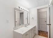 Thumbnail 36 of 47 - a bathroom with a sink and a mirror