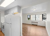 Thumbnail 25 of 47 - an empty living room with a refrigerator and a window