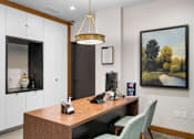 Thumbnail 14 of 47 - a office with a desk and a painting on the wall