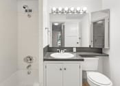 Thumbnail 44 of 47 - a white bathroom with a sink and a toilet
