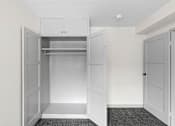 Thumbnail 26 of 47 - an empty closet in a home with white walls and white doors