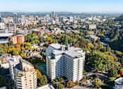 Thumbnail 1 of 47 - an aerial view of a city with tall buildings and trees